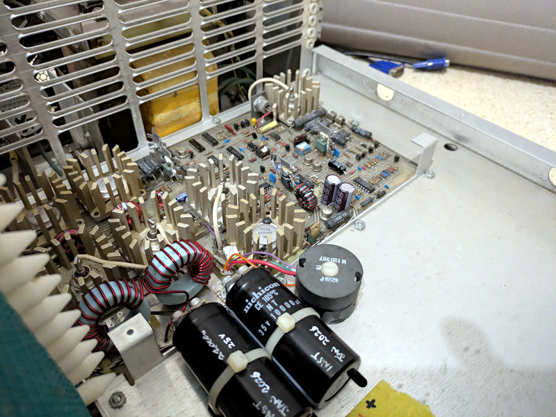 [Really bad picture of the power supply board with new capacitors.]